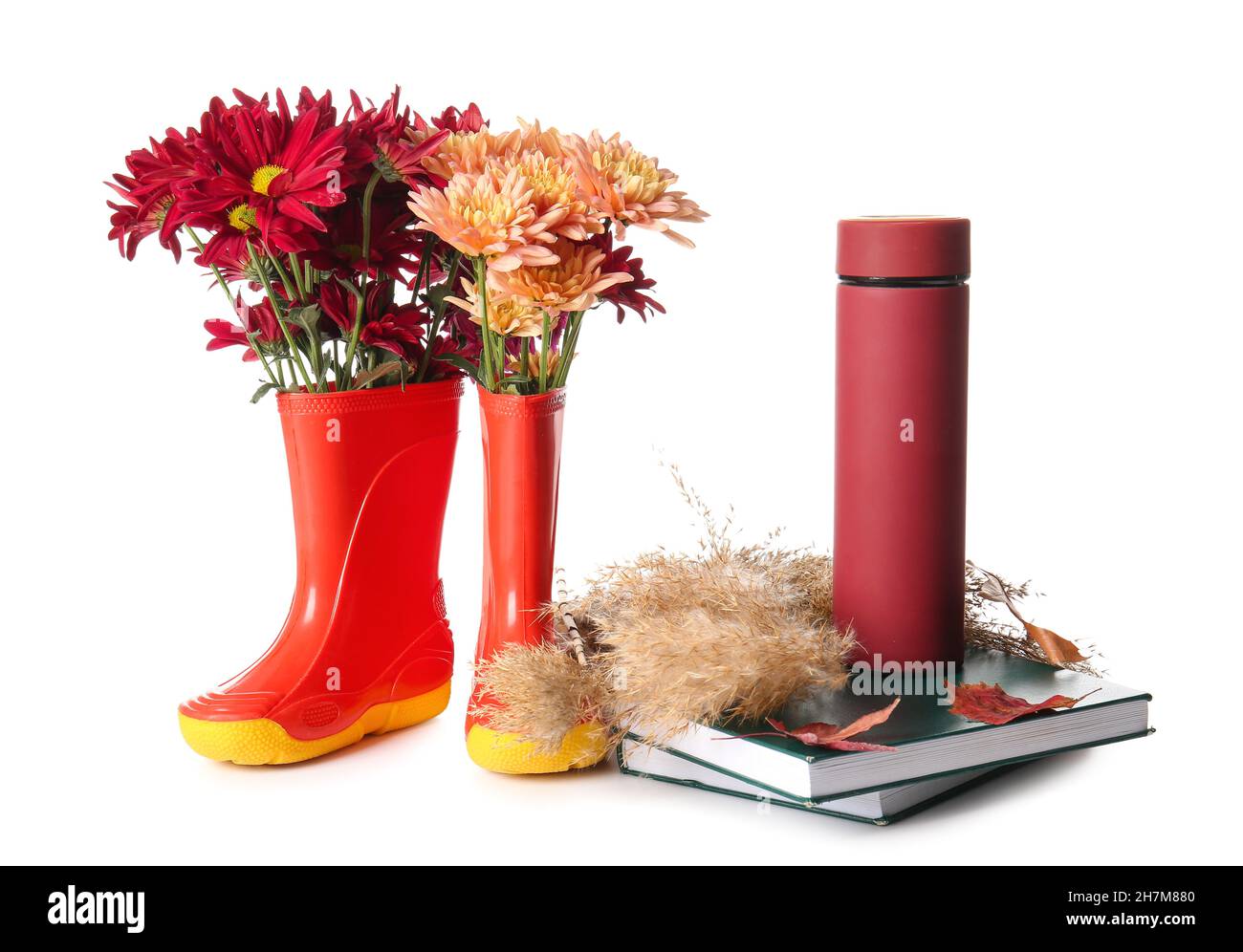 Rubber boots with flowers, thermos and books on white background Stock ...
