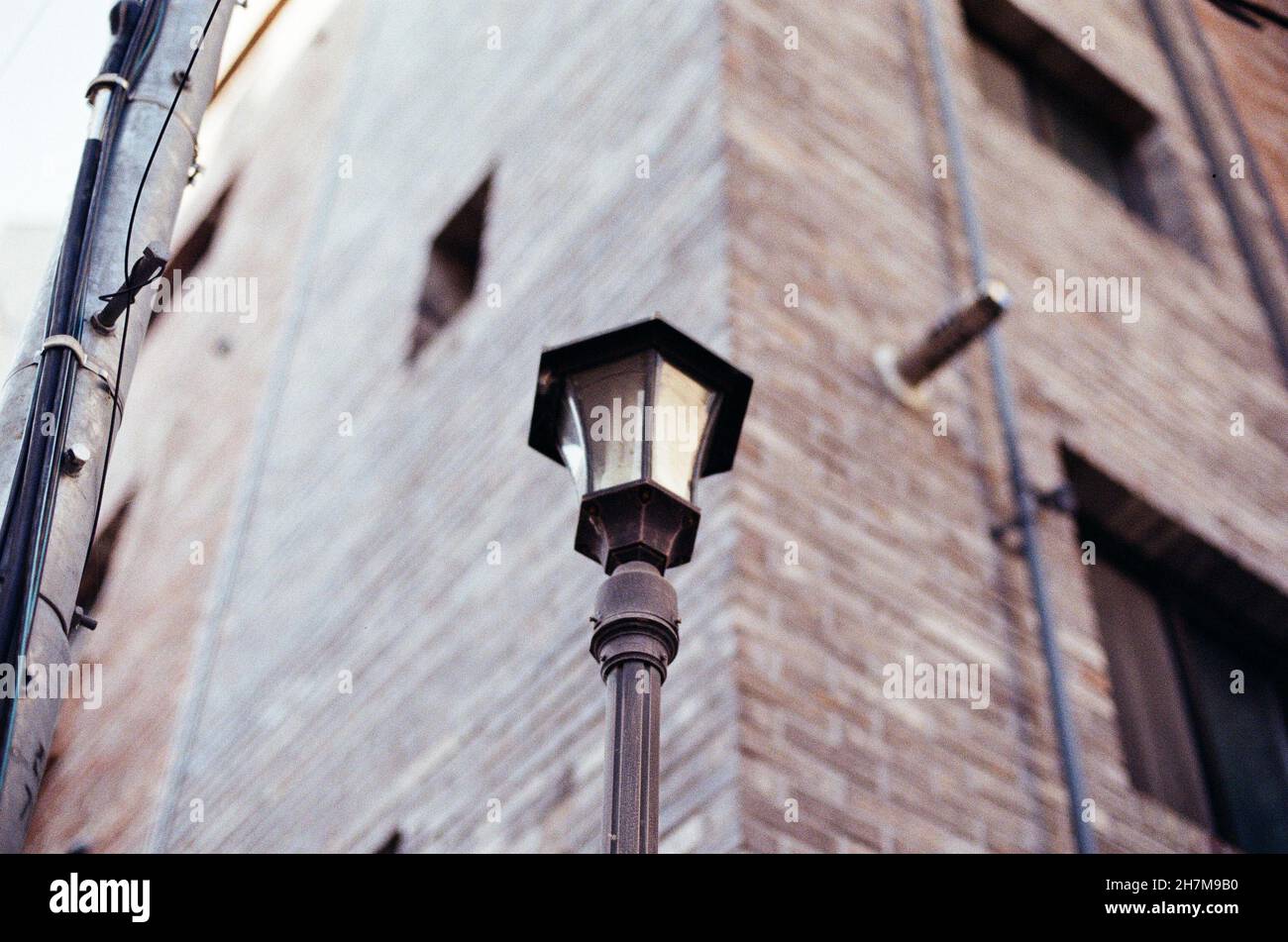 Low angle shot of a vintage street lamp near a brick building Stock ...