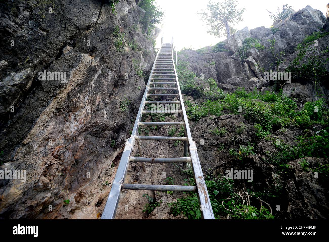 Vertical Standard Fixed Steel Ladder for tourist at Khao Chong Krachok mountain( Wat Thammikaram Worawihan) in prachuap khiri khan Thailand Stock Photo