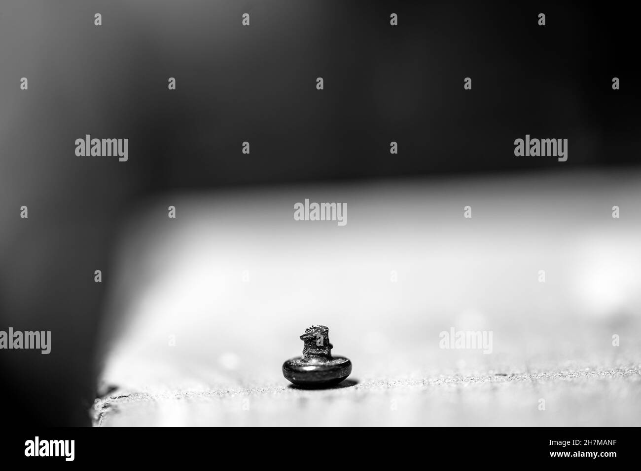 bolt head turned over to show sheared threading after stress failure