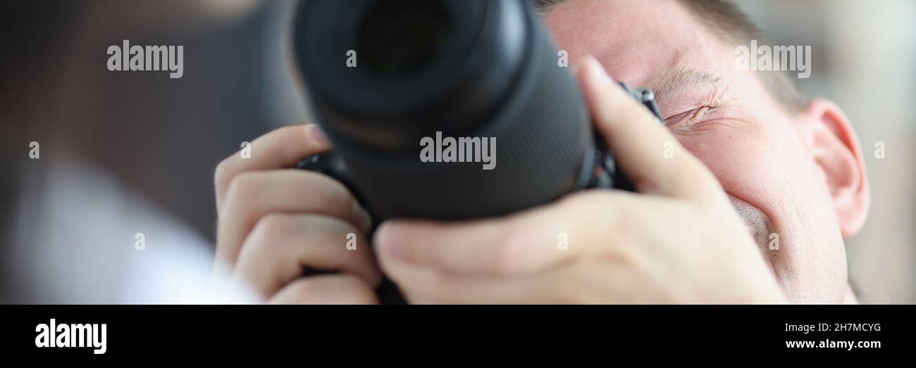 Man photographing woman using black professional camera Stock Photo