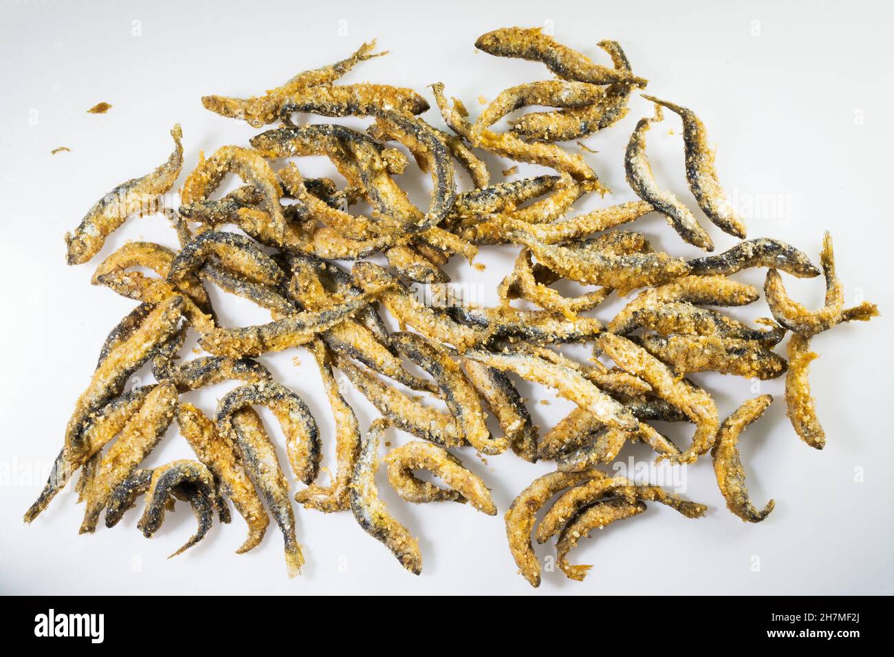 Fried and battered small Vendace fish (Coregonus albula) on whte background Stock Photo