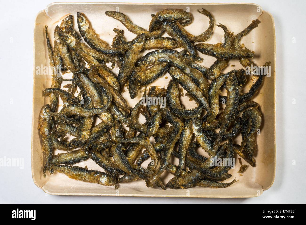 Fried and battered small Vendace fish (Coregonus albula) in a tray Stock Photo