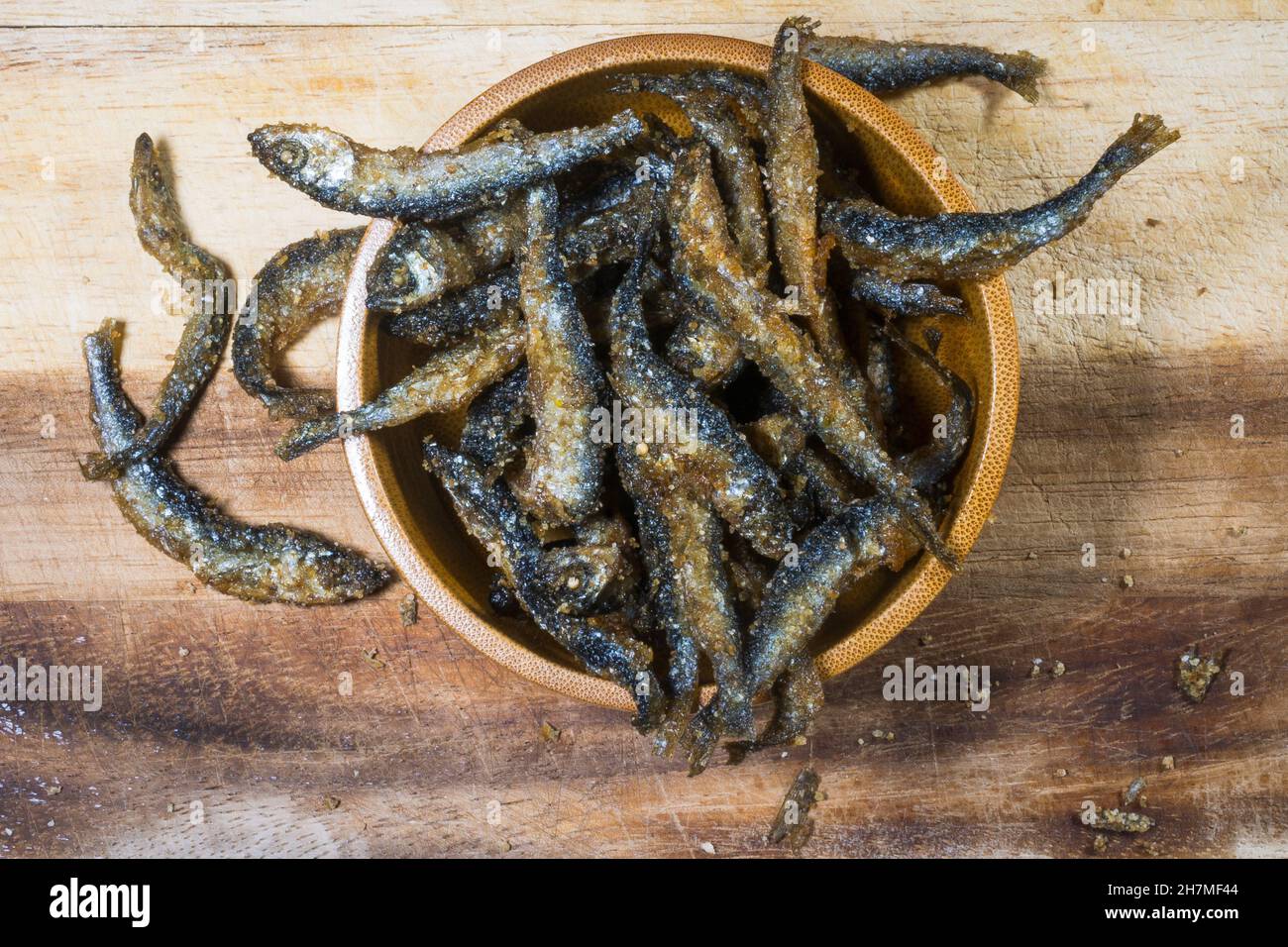 Fried and battered small Vendace (Coregonus albula) fish in a wooden bown Stock Photo