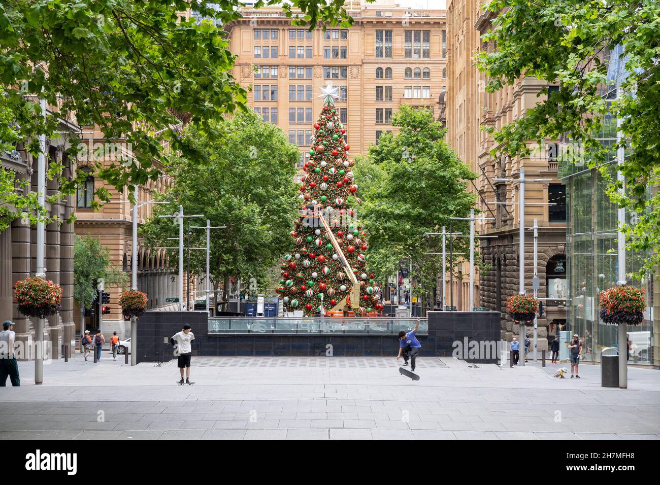 Large decorated Christmas tree with people around at Martin Place in Sydney, Australia on 20 November 20021. Ornaments can be seen on the tree. Stock Photo