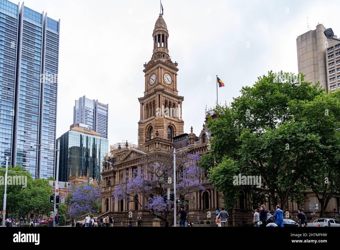 Busy street view of Town Hall and other city buildings at George St, Sydney, Australia on 20 November 2021. Stock Photo