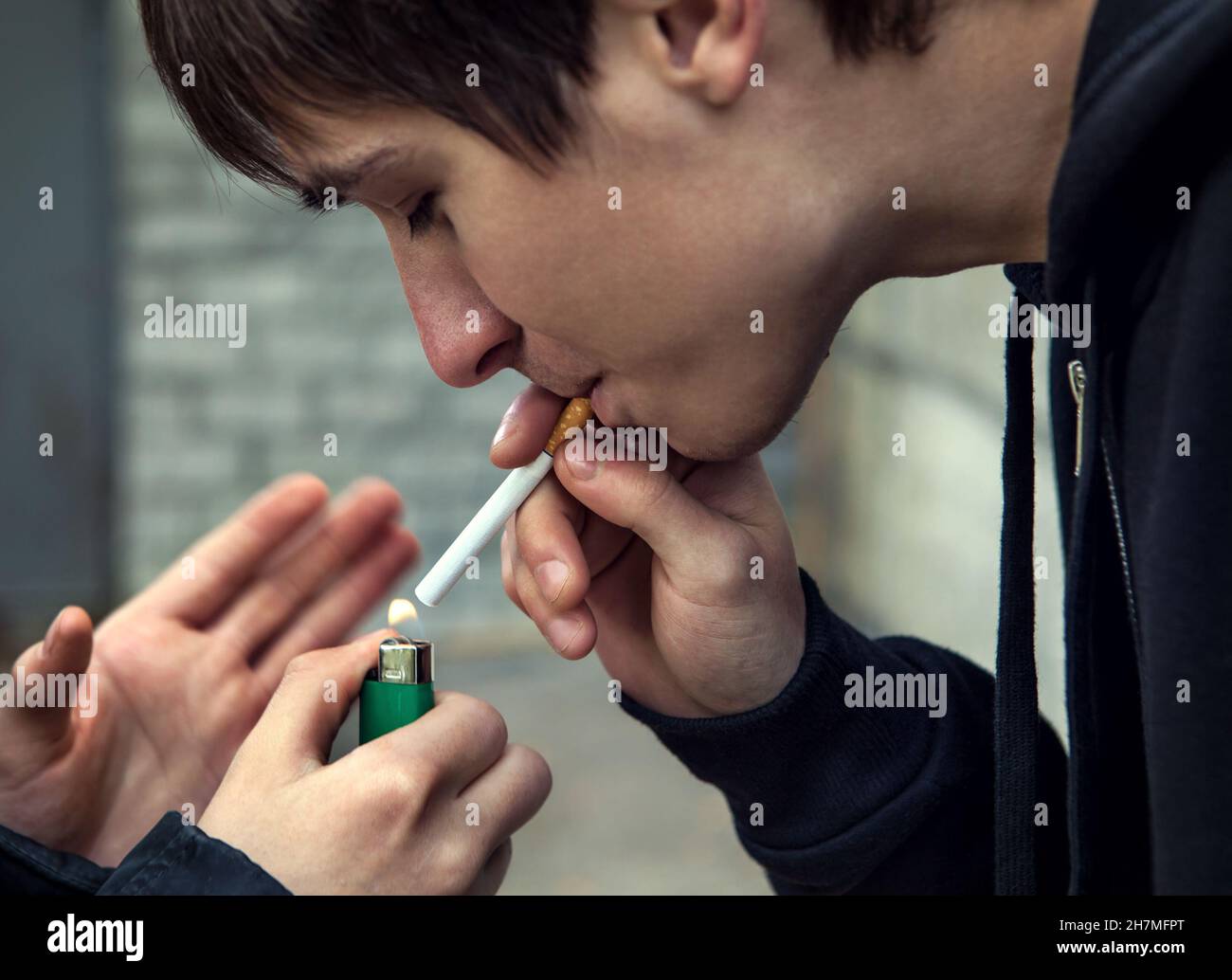 Young Man smoke the Cigarette on the Street Stock Photo - Alamy