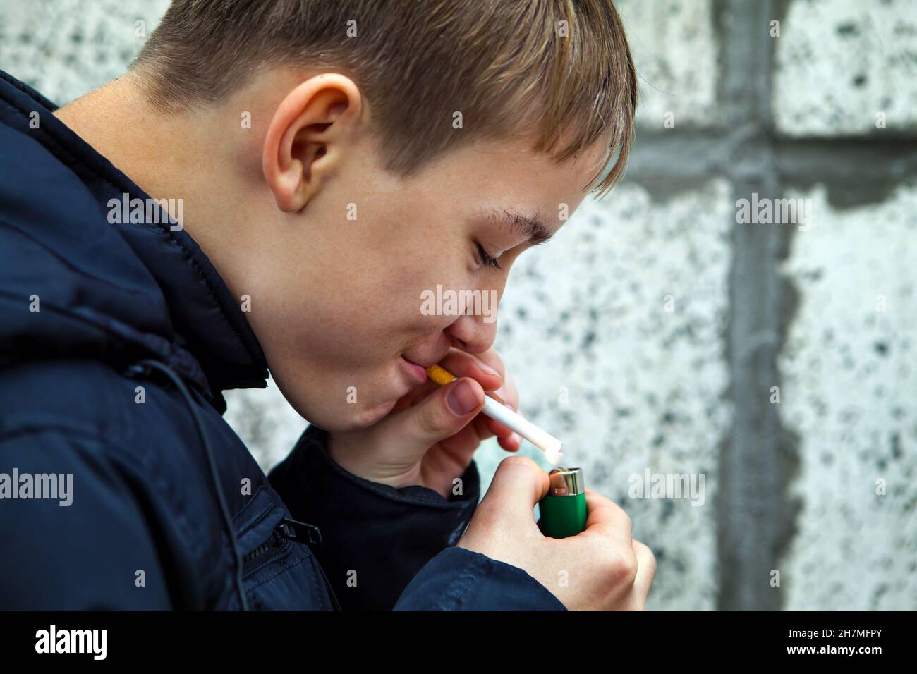 Teenager secretly smoke the Cigarette on the Street Stock Photo