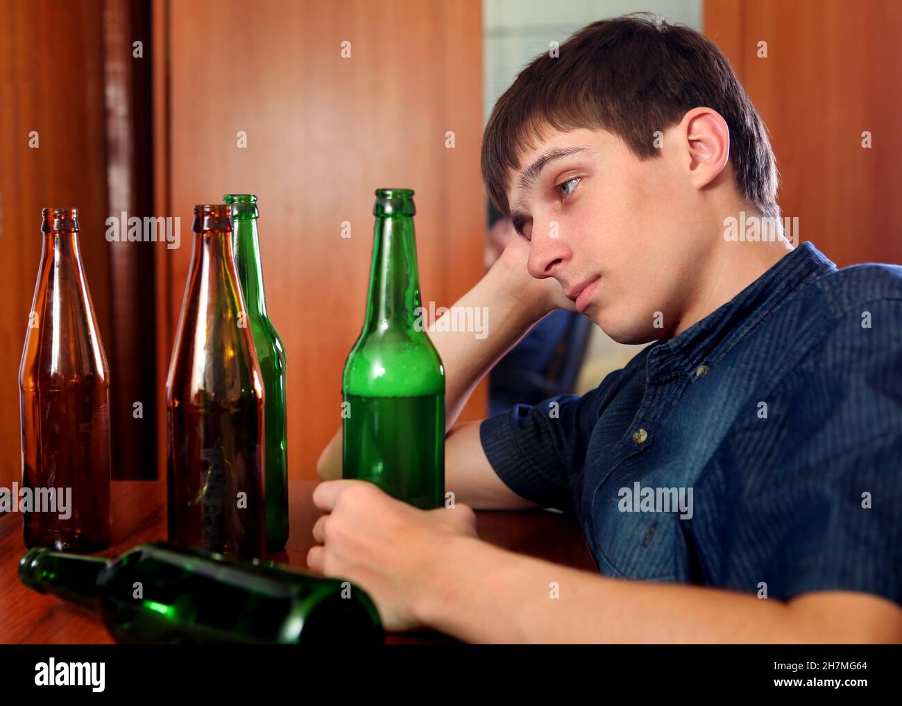 Sad Young Man in Alcohol Addiction at the Home Stock Photo