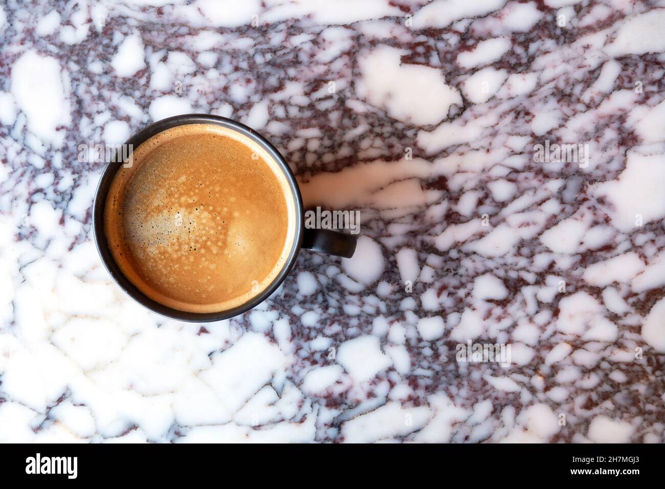 Fresh black coffee in ceramic cup on marble table, top view Stock Photo