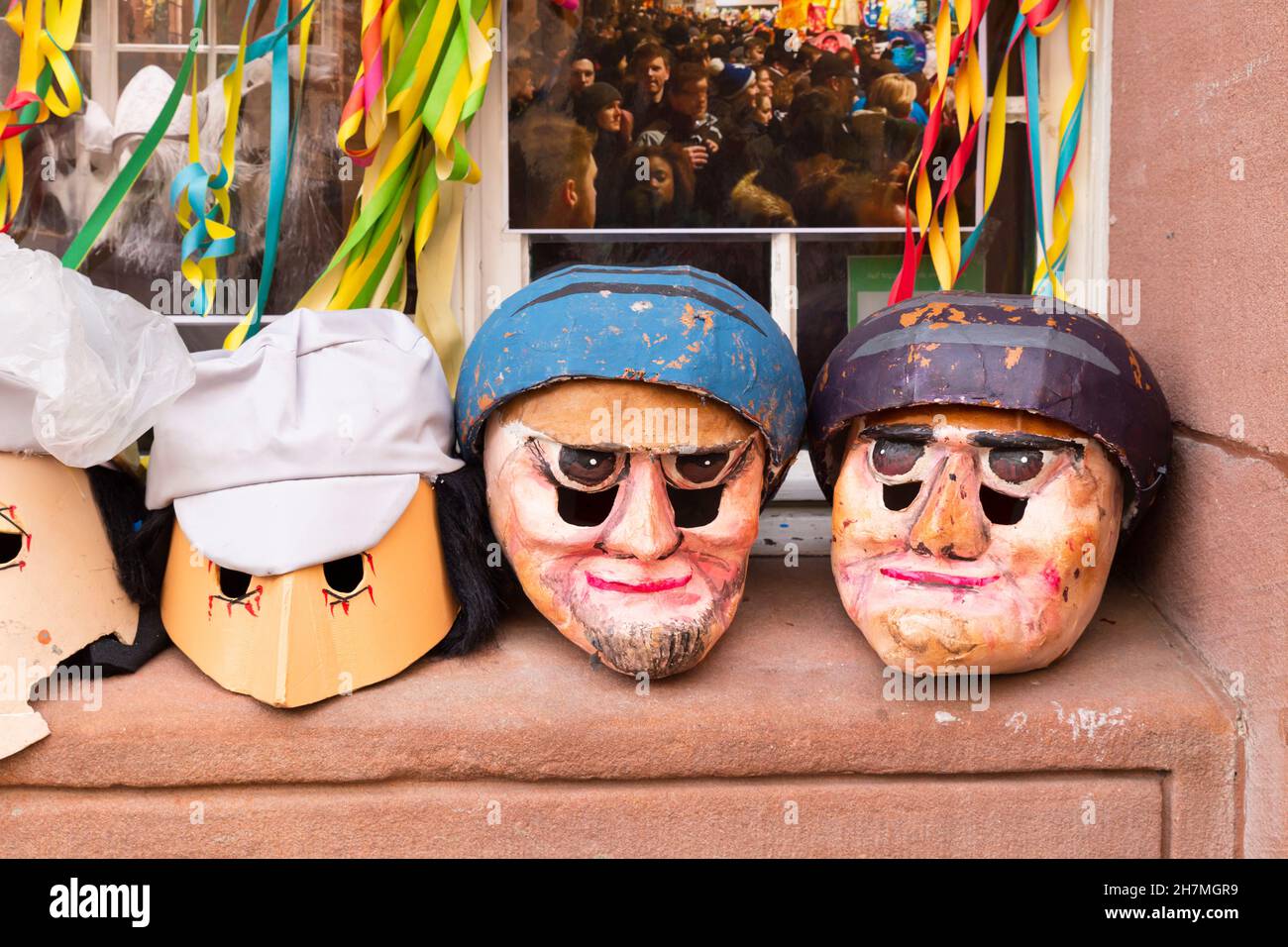 Basel, Switzerland - February 21. Four carnival masks sitting on a window sill Stock Photo