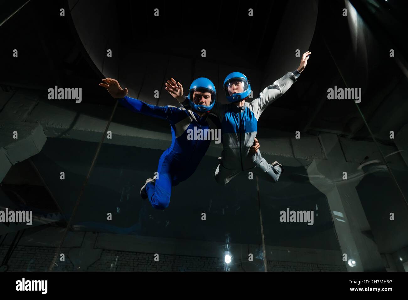 A man and a woman enjoy flying together in a wind tunnel. Free fall ...