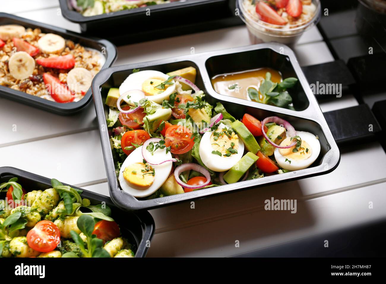 Diet box with egg and avocado salad, appetizing take-away meal. Appetizing ready-to-go dish served in a disposable box. Culinary photography.y photog Stock Photo