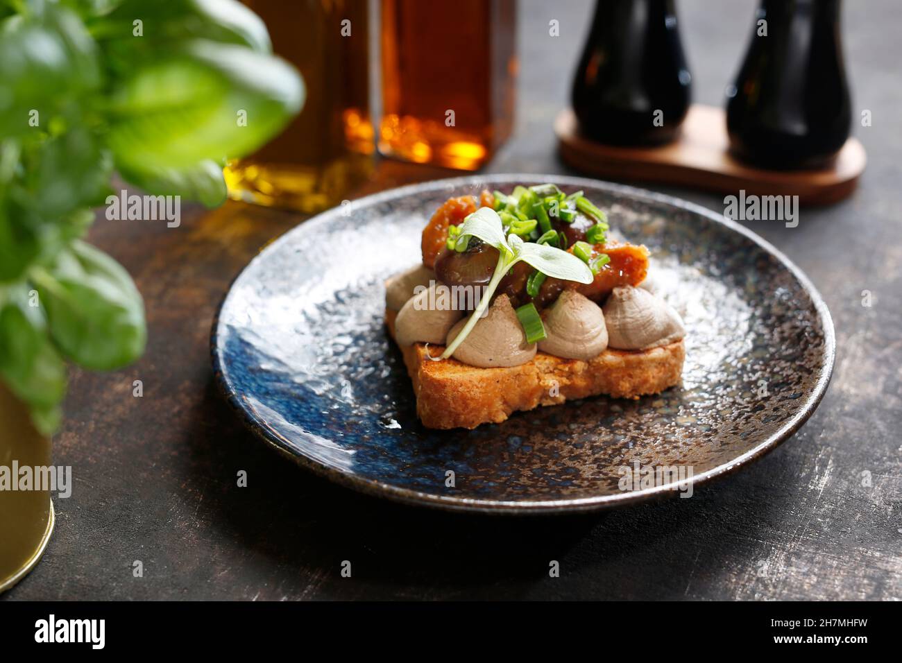 Sandwich with mousse, grilled mushrooms and chives. Appetizing dish. Culinary photography, a proposal to serve a meal. Stock Photo