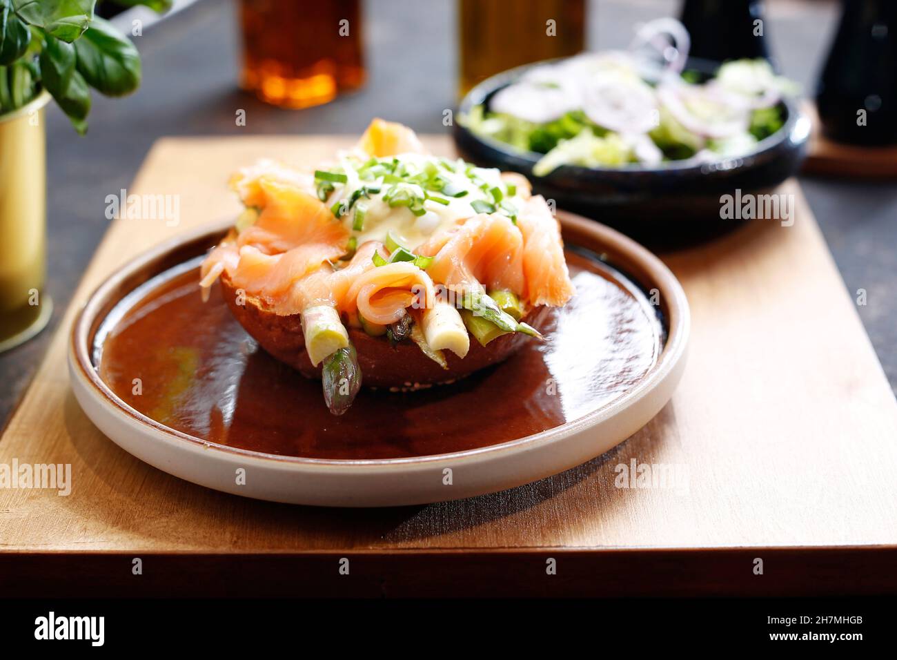 Sandwich with smoked salmon and asparagus, served with a green salad. A tasty dish.Culinary photography. Suggestion to serve the dish. Stock Photo