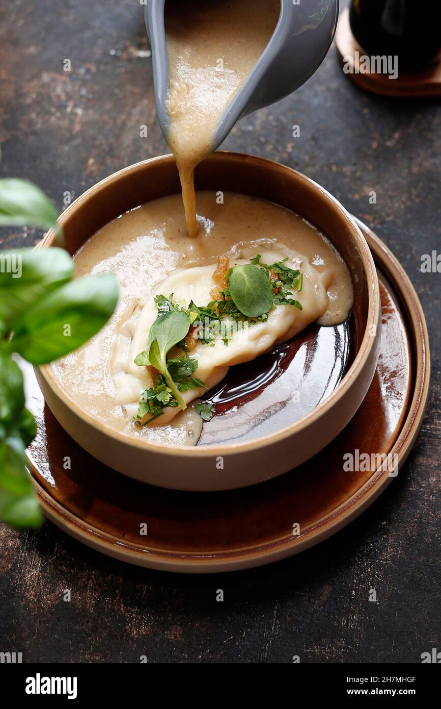 Mushroom cream soup with dumplings. A warming soup. A tasty dish.Culinary photography. Suggestion to serve the dish. Stock Photo