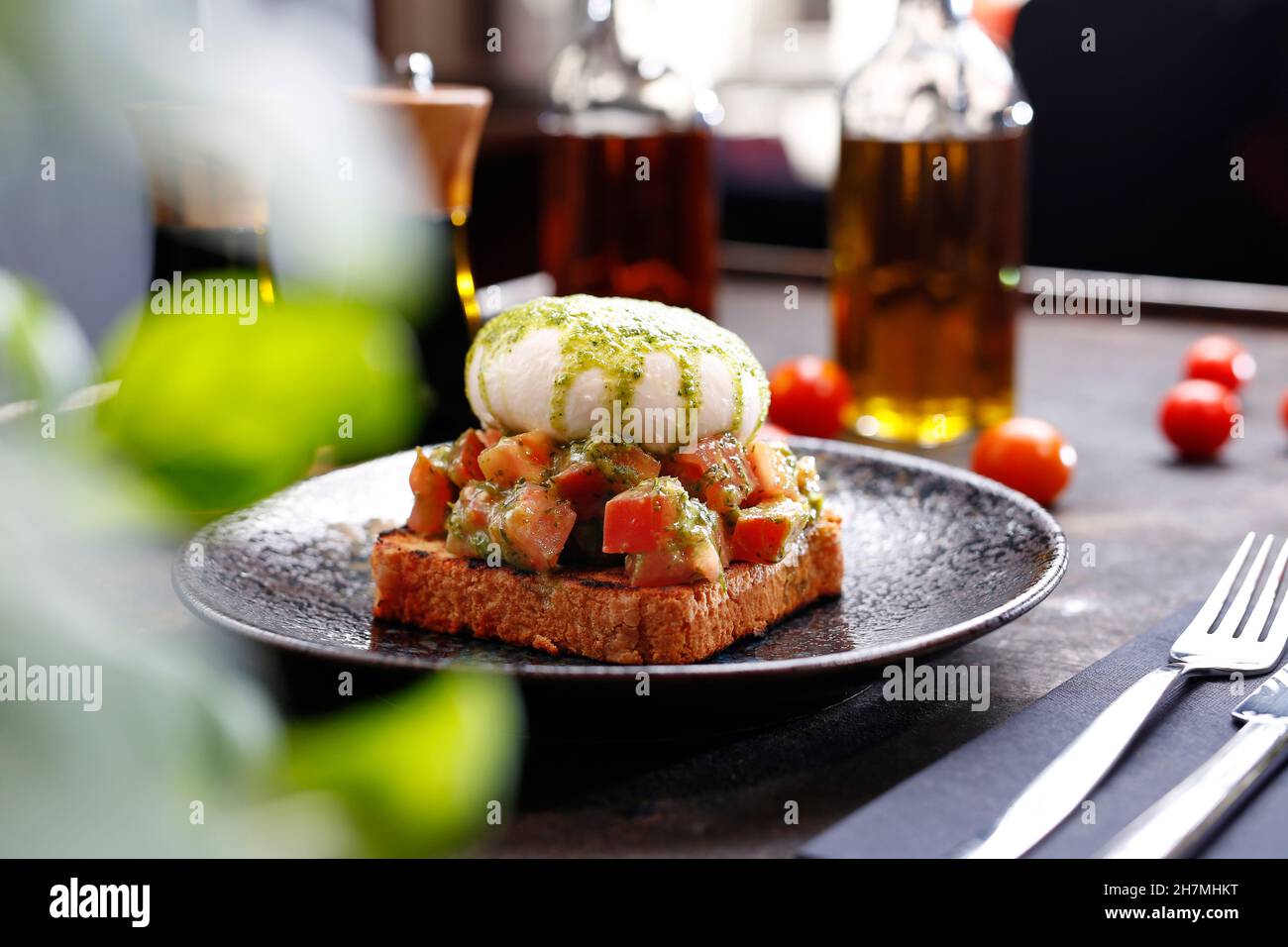 Bruschetta with burrata and basil pesto. Appetizing dish. Culinary photography, a proposal to serve a meal. Stock Photo