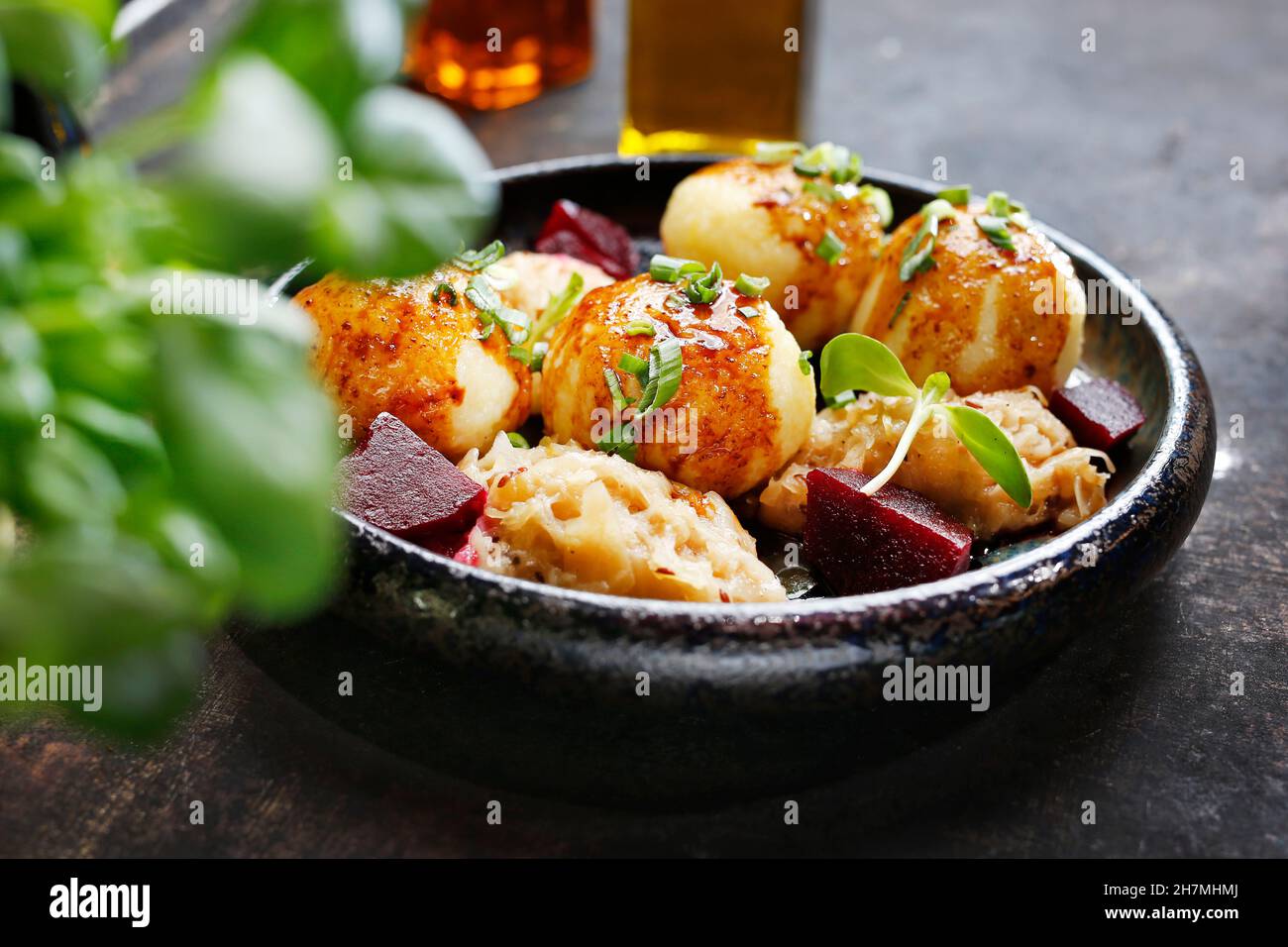 Dumplings with meat and sauce served with boiled cabbage and beetroot. A tasty dish.Culinary photography. Suggestion to serve the dish. Stock Photo