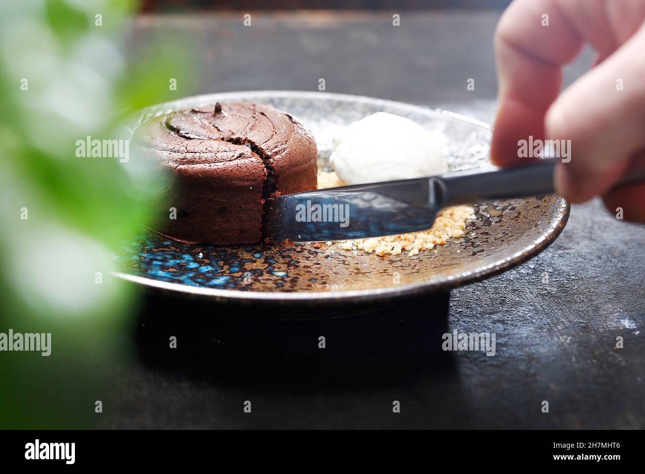 Chocolate cake with ice cream and nuts. Tasty sweet dessert. A tasty dish.Culinary photography. Suggestion to serve the dish. Stock Photo