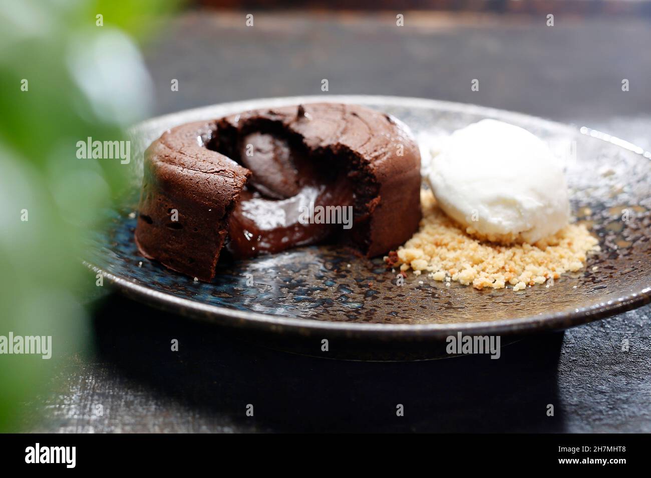 Chocolate cake with ice cream and nuts. Tasty sweet dessert. A tasty dish.Culinary photography. Suggestion to serve the dish. Stock Photo