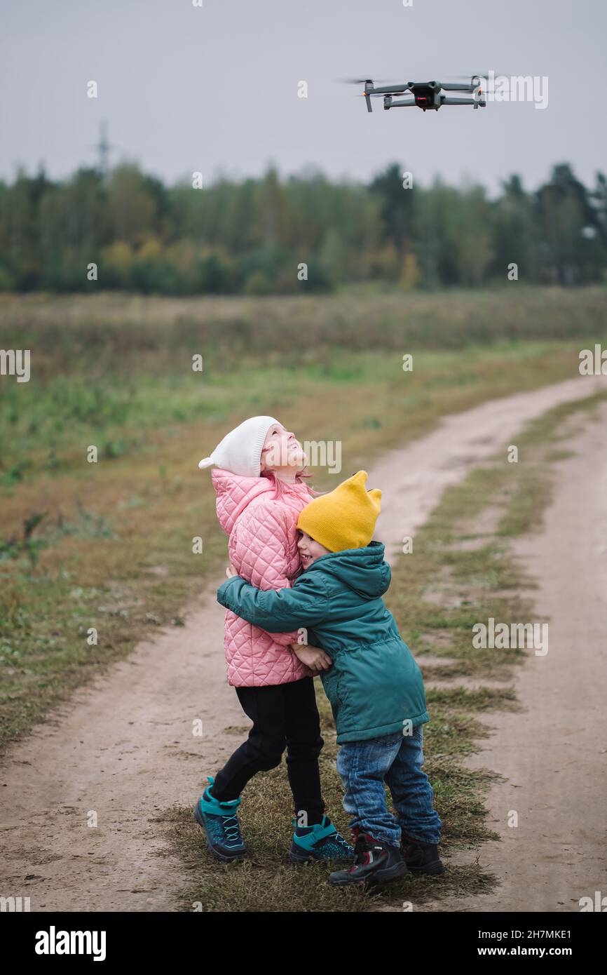 Little caucasian children playing in the field autumn time. Stock Photo