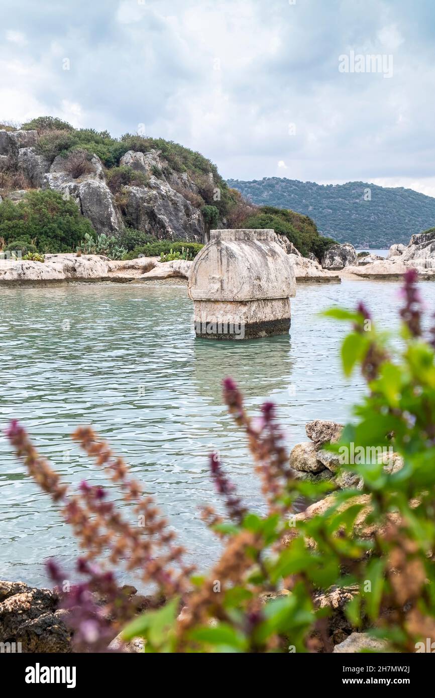 Seascape of Simena, Kekova Ancient Lycian City in Demre, Antalya, with a big sarcophagus in the sea. Stock Photo
