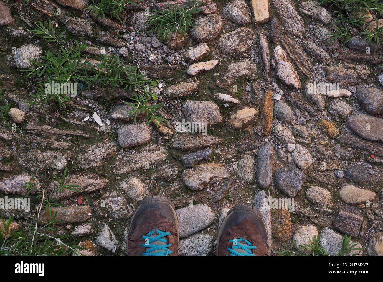 Cobblestones with shoes, shoes on pavement, historic road construction