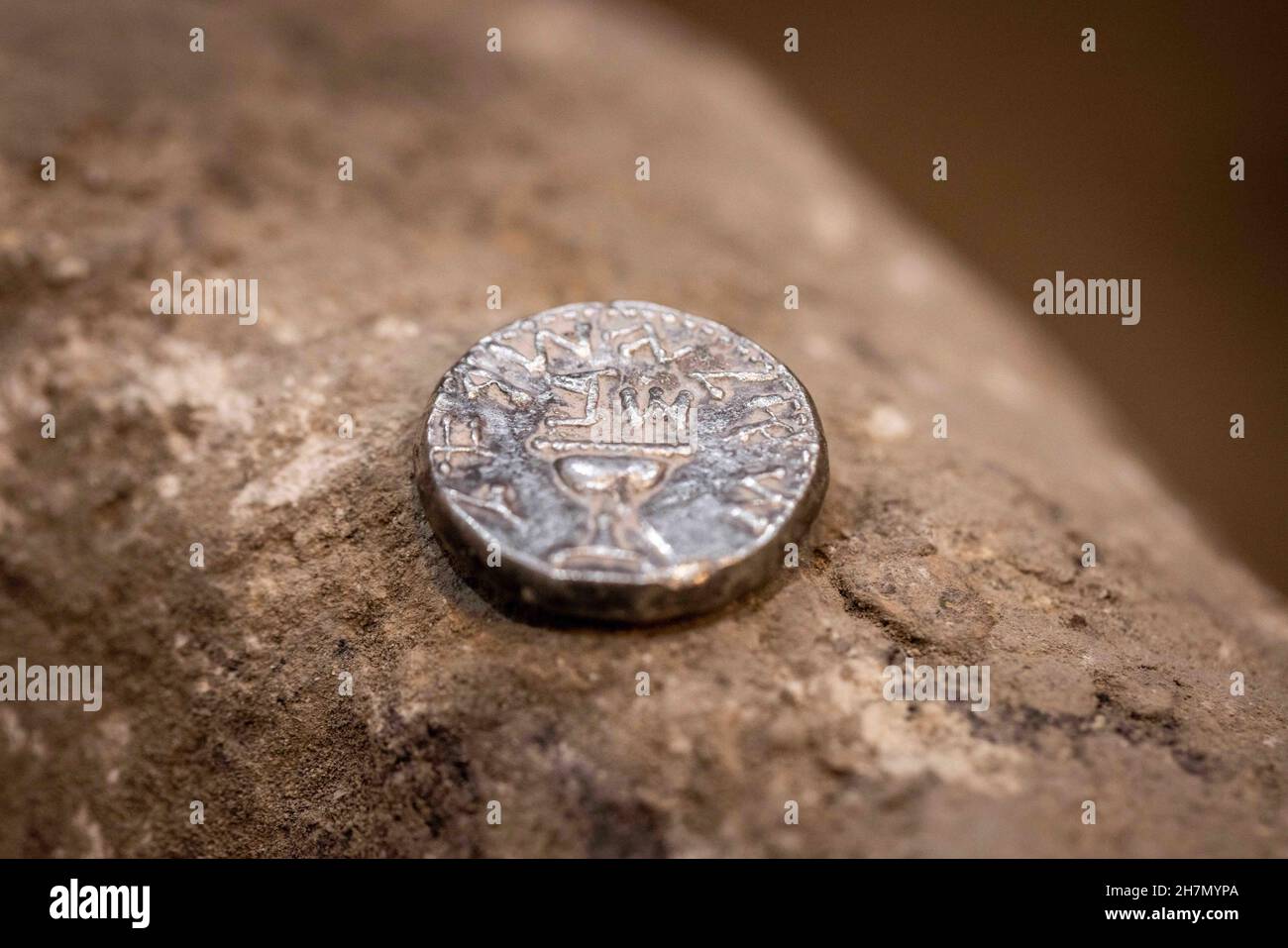 (211124) -- JERUSALEM, Nov. 24, 2021 (Xinhua) -- Photo taken on Nov. 23, 2021 shows the ancient silver coin dating back to about 2,000 years ago in Jerusalem. An ancient shekel, dating back to about 2,000 years ago, was discovered in Jerusalem, the Israel Antiquities Authority (IAA) said on Tuesday. The shekel, which weighs about 14 grams, was probably minted by one priest of the Jewish Second Temple, shortly before the destruction of the temple. (JINI via Xinhua) Stock Photo