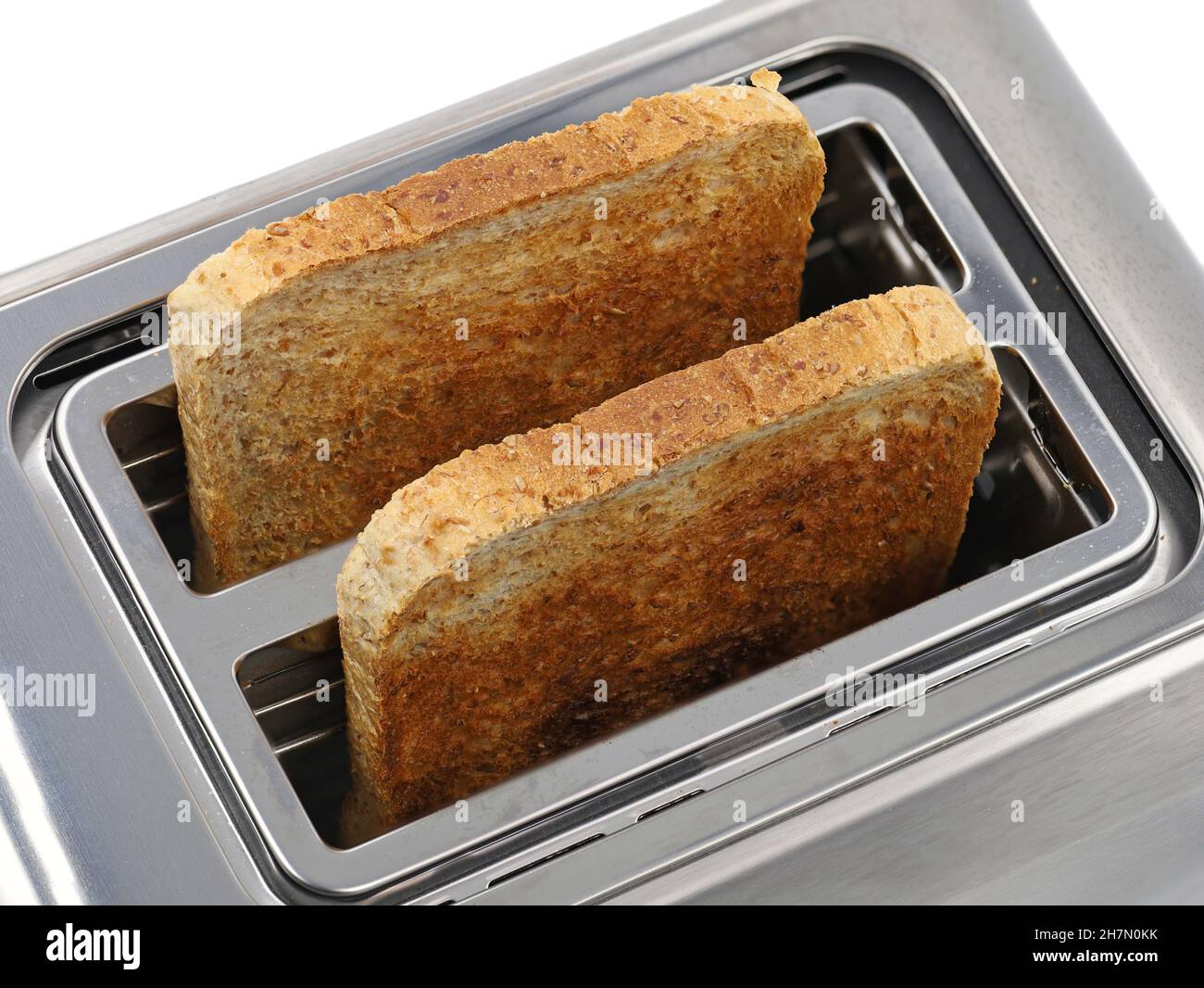 top view of stainless steel toaster with two toasted slices multigrain