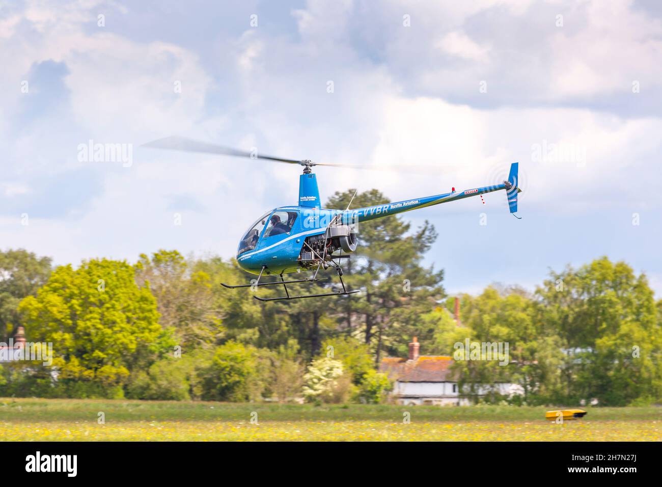 Small blue helicopter taking off from Halfpenny Green airfield, UK, locally known as Bobbington Airport. Stock Photo