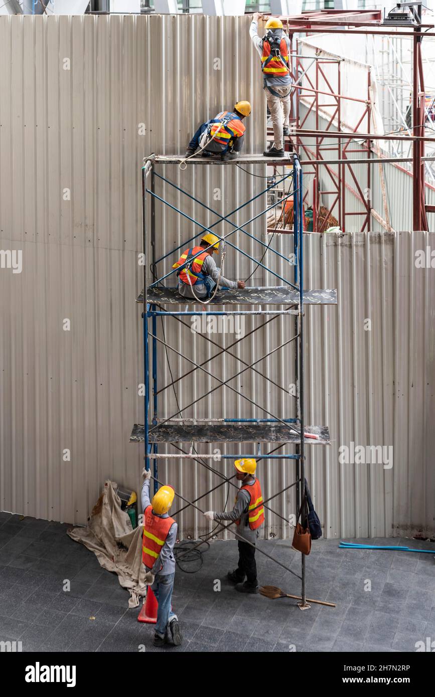 Construction worker on scaffolding, Bangkok, Thailand Stock Photo