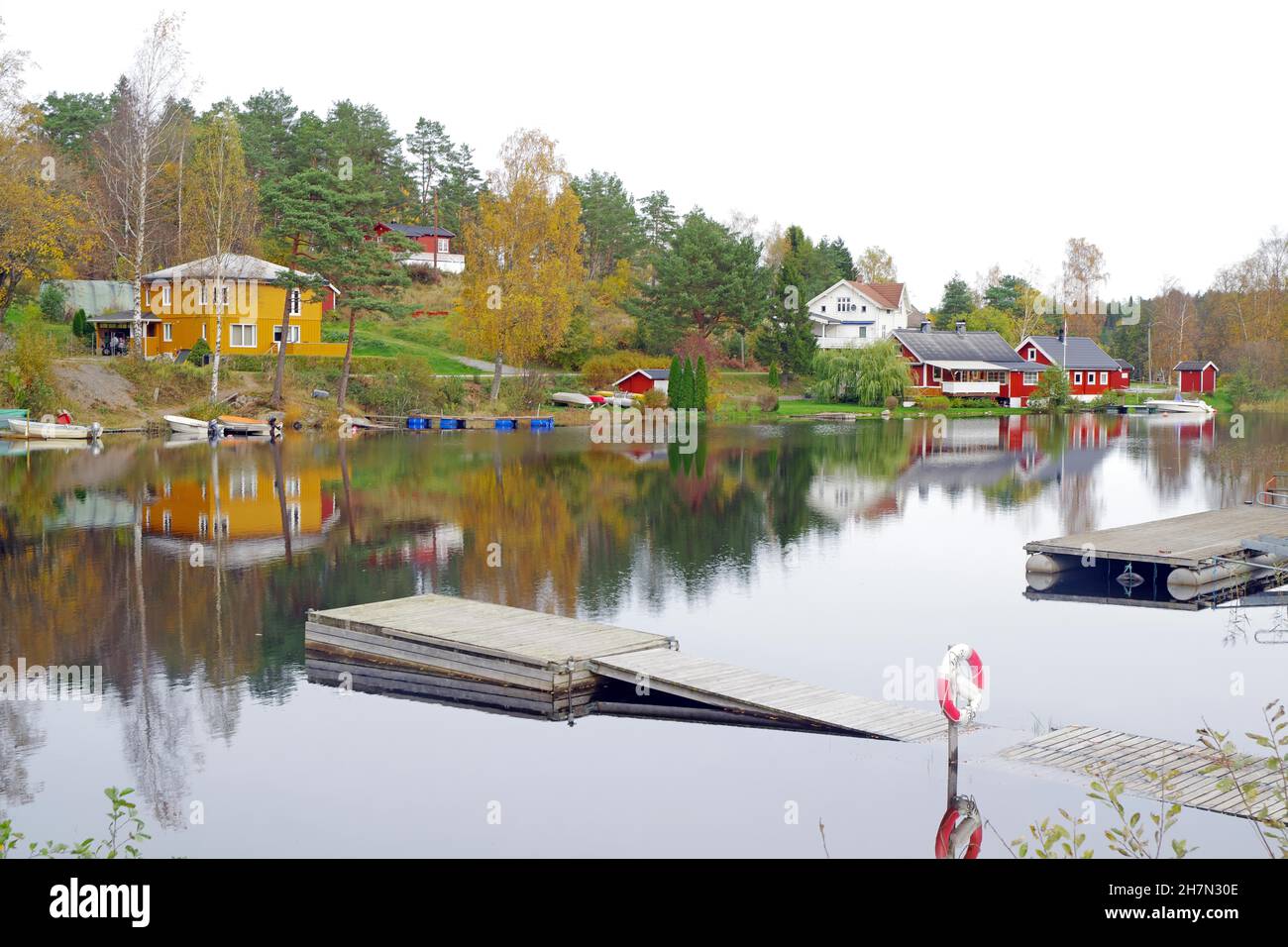 Left Norway, Right Sweden, Houses reflected in the water at the Norwegian-Swedish border, Kornsjo, Norway, Sweden Stock Photo