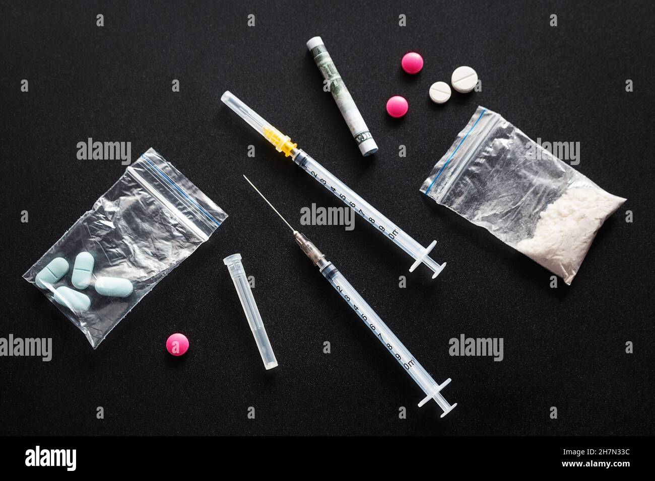 syringes and drugs pills on black background Stock Photo