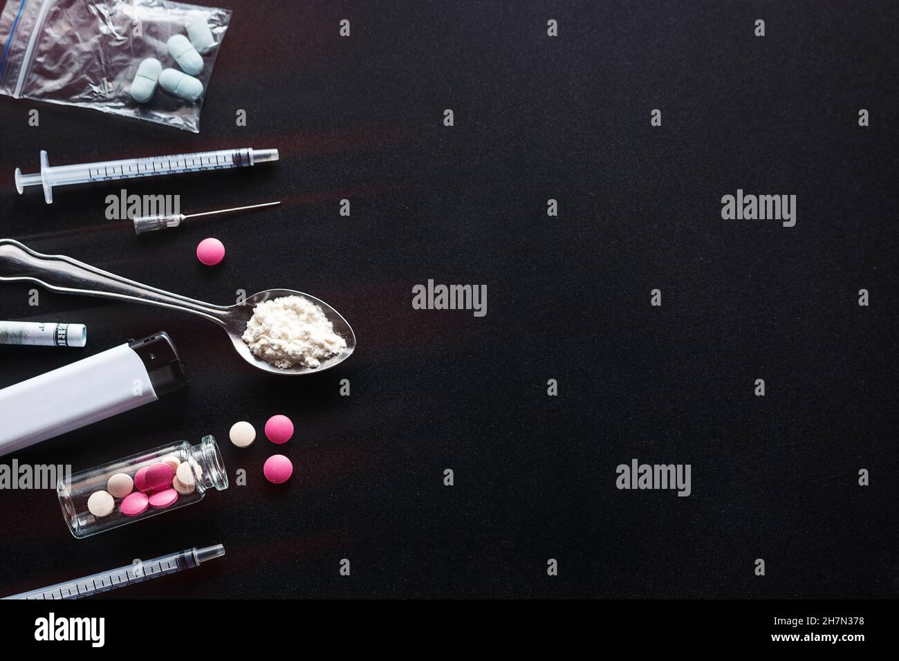 hard drugs, syringe, heroin on dark background with red glow and place for text concept of danger stop addiction drug trafficking Stock Photo