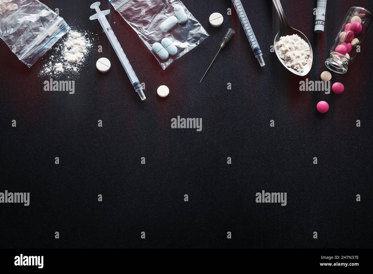hard drugs on dark background with red glow and place for text concept