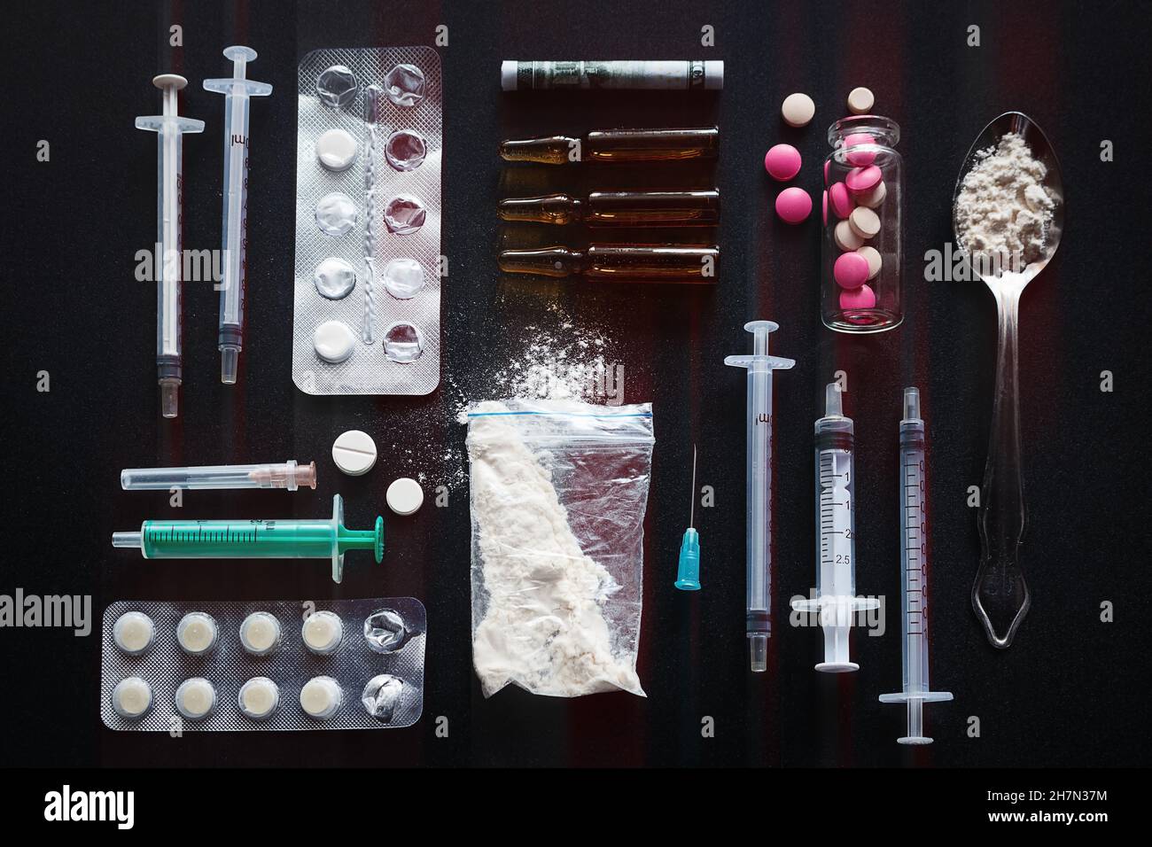 syringes, drugs on black background addiction concept Stock Photo