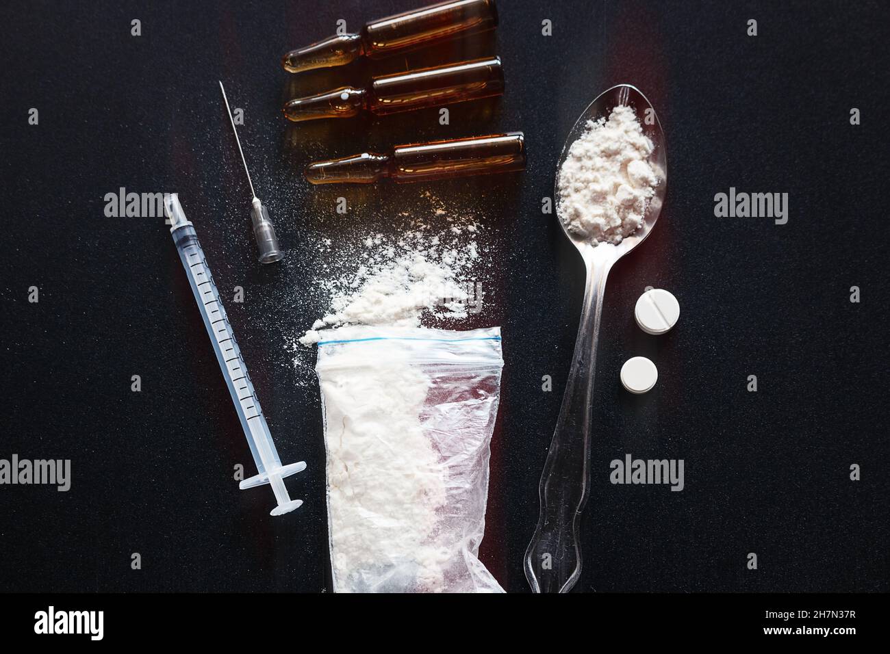 drugs, pills, heroin in a spoon on a dark background Stock Photo