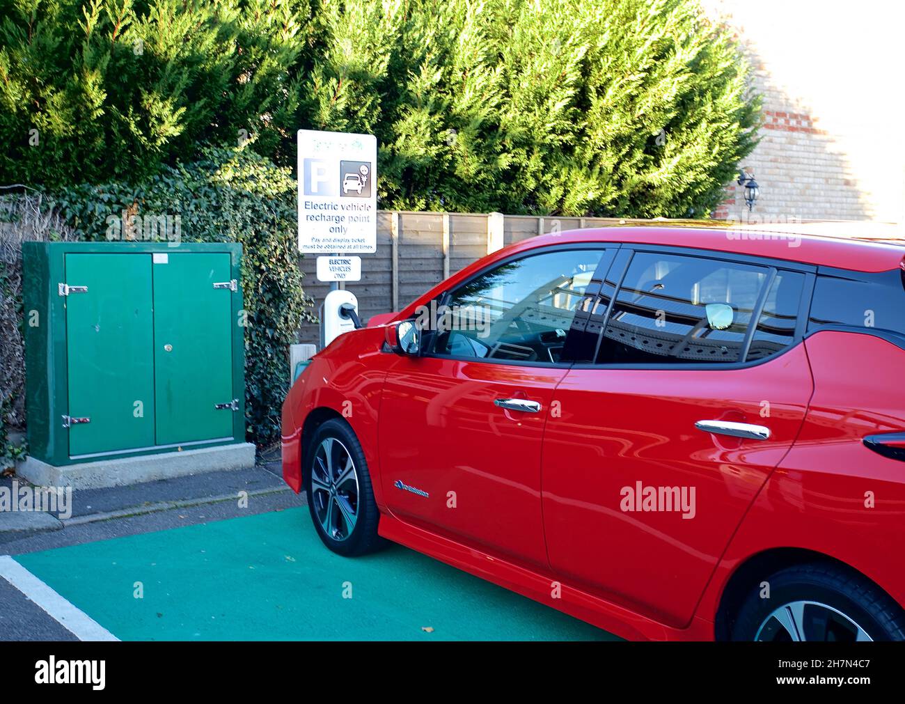 Charging port and parking to charge an electric vehicle at a Tendring District car park in Clacton on Sea. Stock Photo