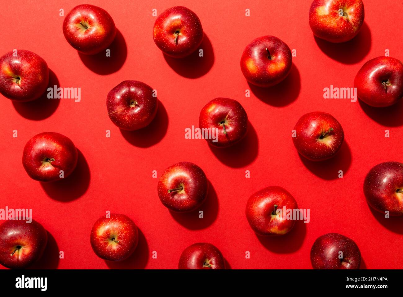 Many red apples on colored background, top view. Autumn pattern with ...