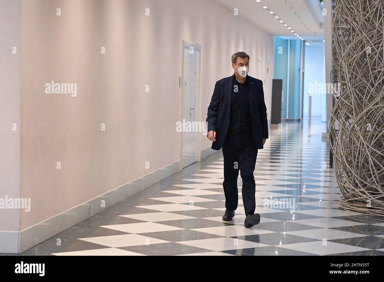 Markus SOEDER (Prime Minister Bavaria and CSU Chairman) walks alone down a long hallway. Press appointment for flu vaccination Prime Minister Soeder and Health Minister Holetschek on November 24th, 2021 in the Bavarian State Chancellery in Munich. Stock Photo