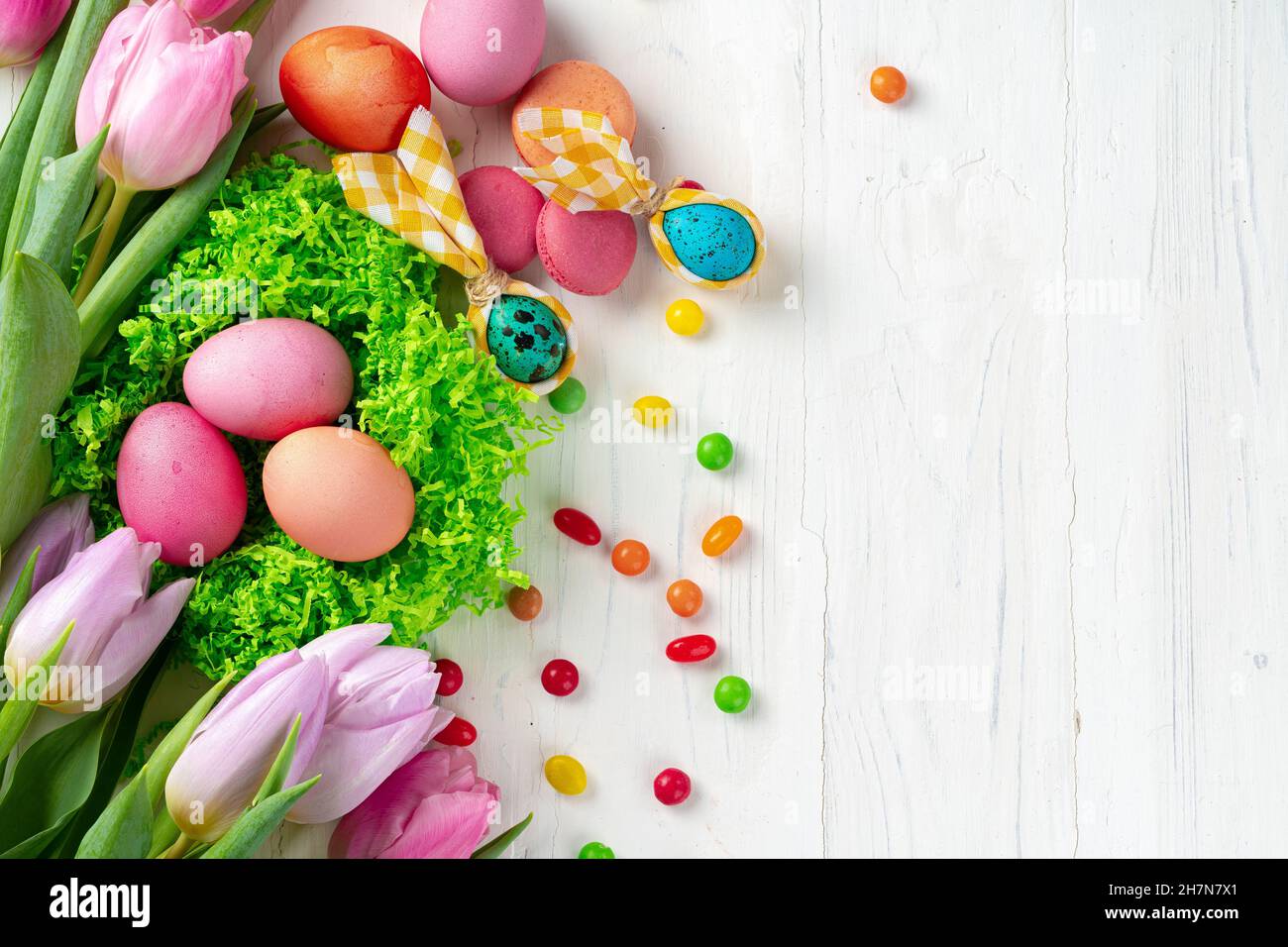 Easter composition with tulips and basket of painted eggs Stock Photo ...