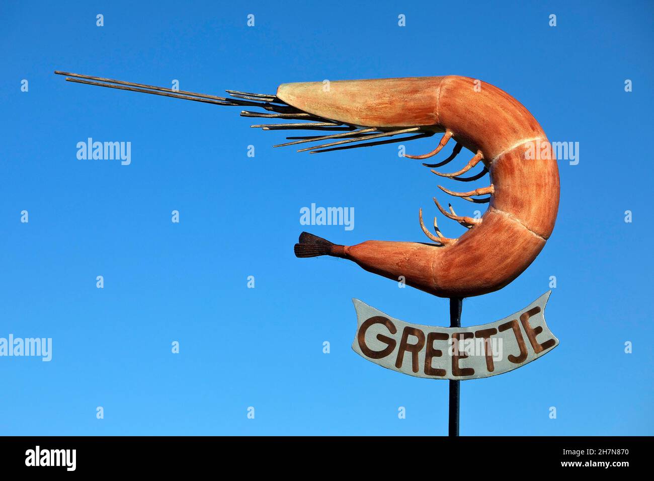 The sculpture of the North Sea crab Greetje at the fishing harbour against a blue sky, Greetsiel, East Frisia, Lower Saxony, Germany Stock Photo