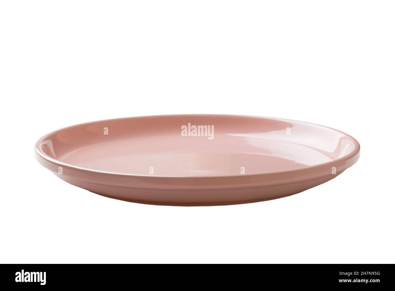 Pink ceramic round plate isolated over white background. perspective ...