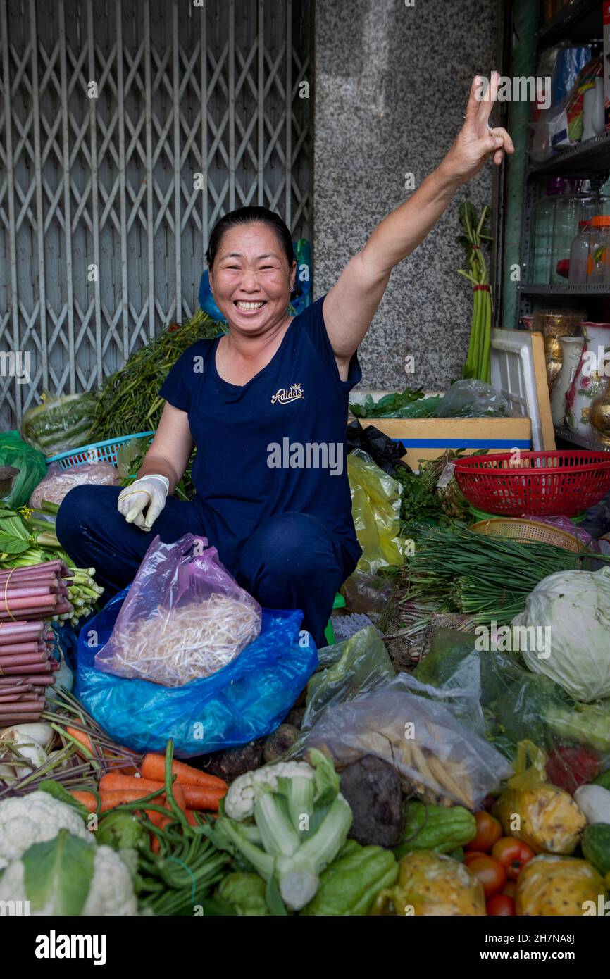 Can tho, Vietnam-April 5, 2018: Women sell fruits and vegetables in the street of Can Tho. Stock Photo