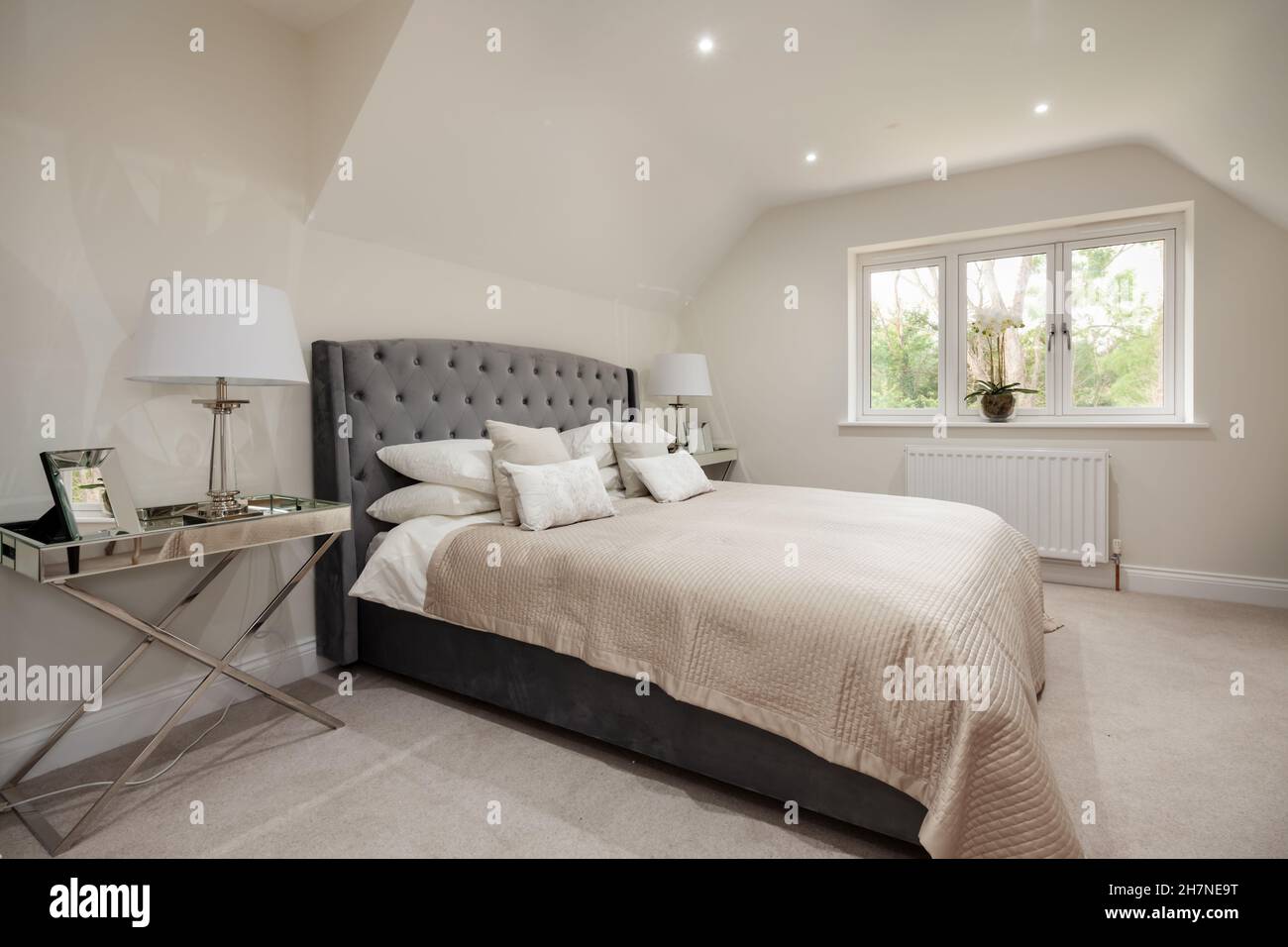 Dry Drayton, Cambridgeshire - October 31 2019: Home marketing staging in new house bedroom fully dressed as example arrangement of furnishing Stock Photo