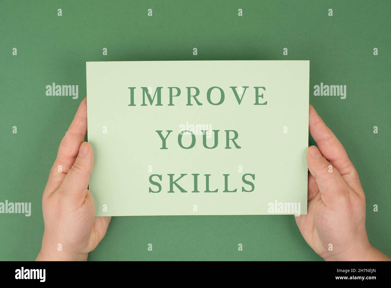 The words improve your skills are standing on a green colored paper