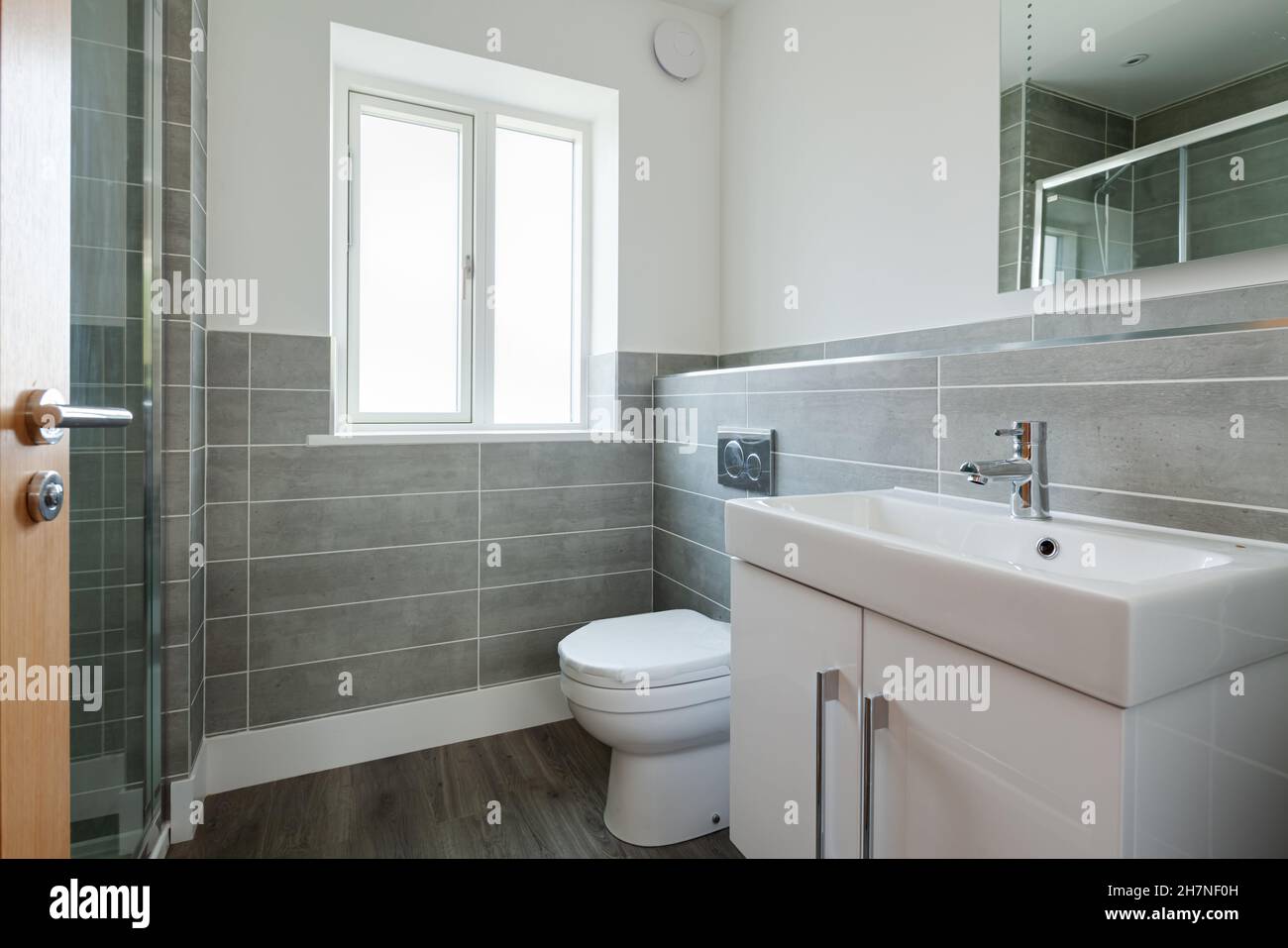 Generic modern home or apartment shower room with partially tiled walls ...