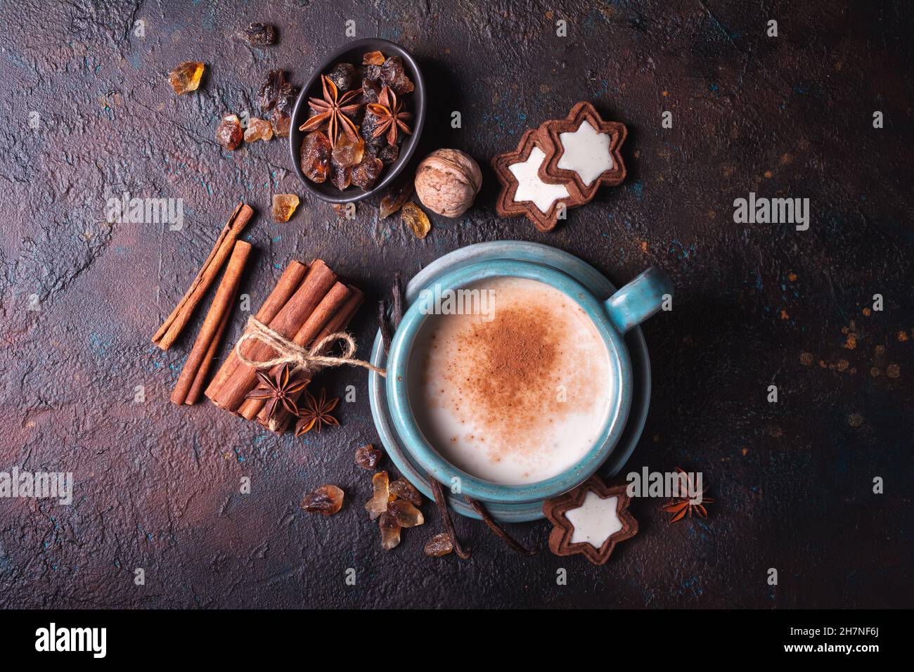 Top view of homemade traditional Christmas hot drink Eggnog with cinnamon, anise, vanilla, cookies and nuts Stock Photo