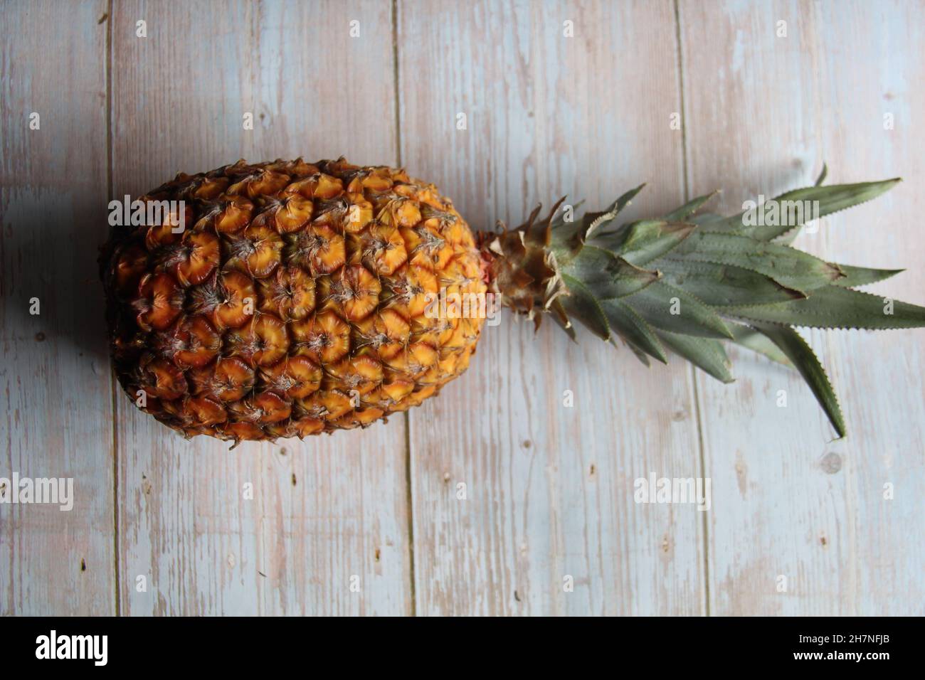 Hawaiian pineapple, isolated, on an old wooden table, Top view. Stock Photo