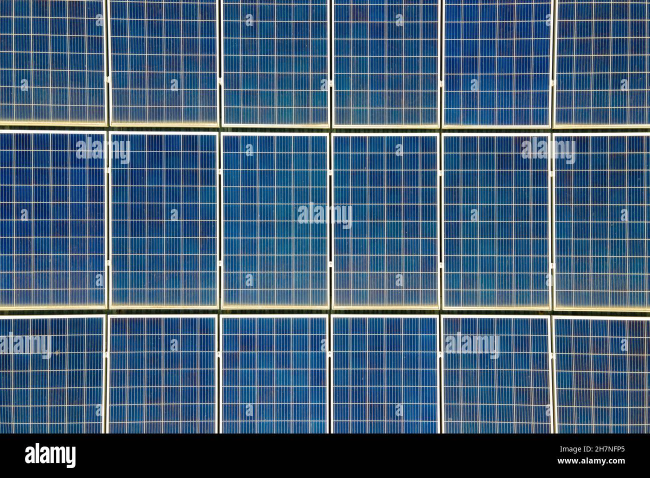 Closeup of surface of blue photovoltaic solar panels mounted on ...